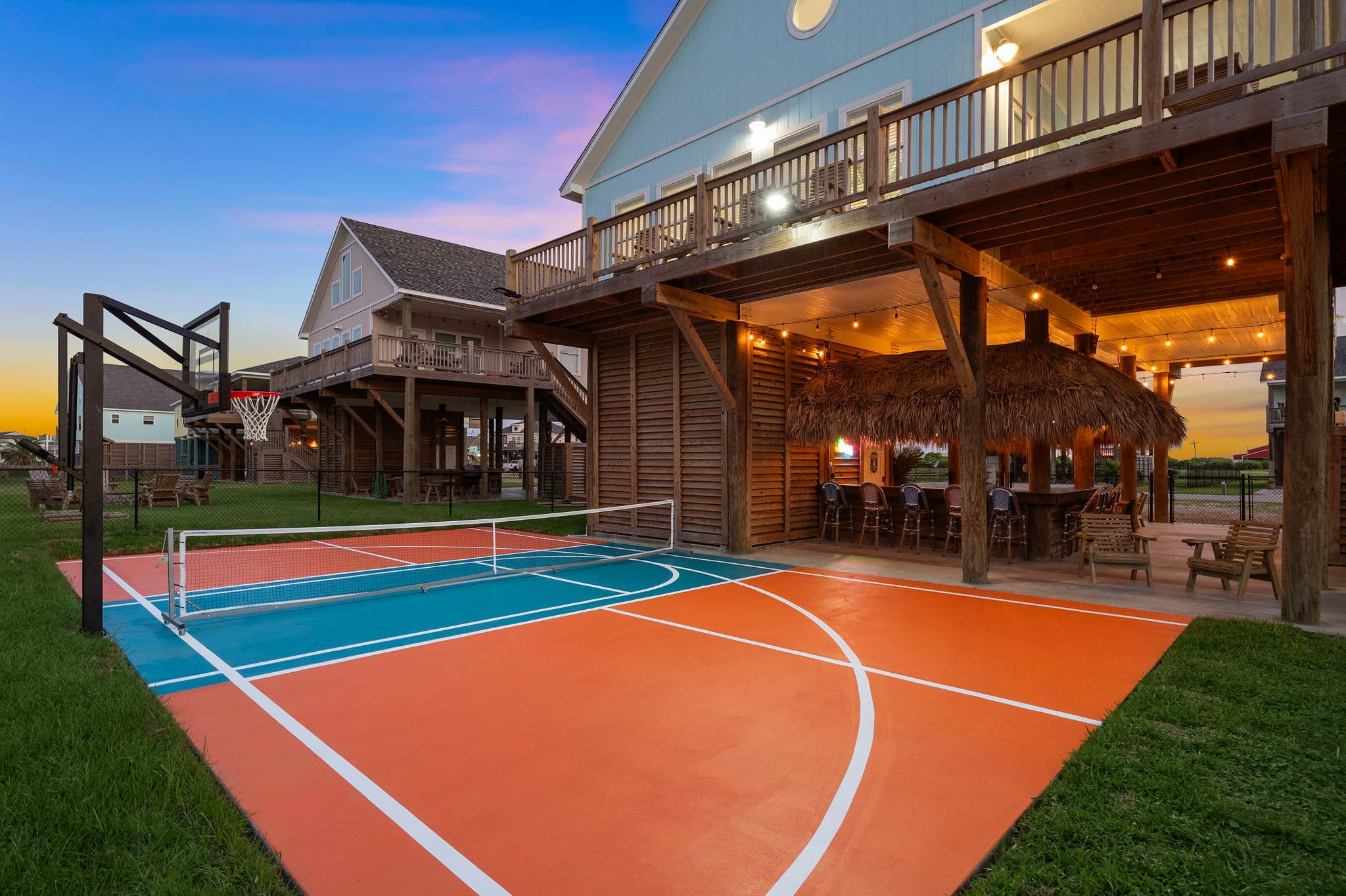 Pickle Beach - Basketball court and tiki bar at twilight
